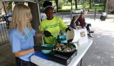 A July 15 cooking demo was led by Marin Rubin, 20, left, and Mariam Keita, 16, right. Fresh cabbage, carrot and onion sizzled on the pan as students offered samples of veggie stir fry, explaining it&rsquo;s an easy meal to make with rice, noodles or protein. Keita said she enjoys being an advocate for fair access to healthy food, especially in a neighborhood with few options.