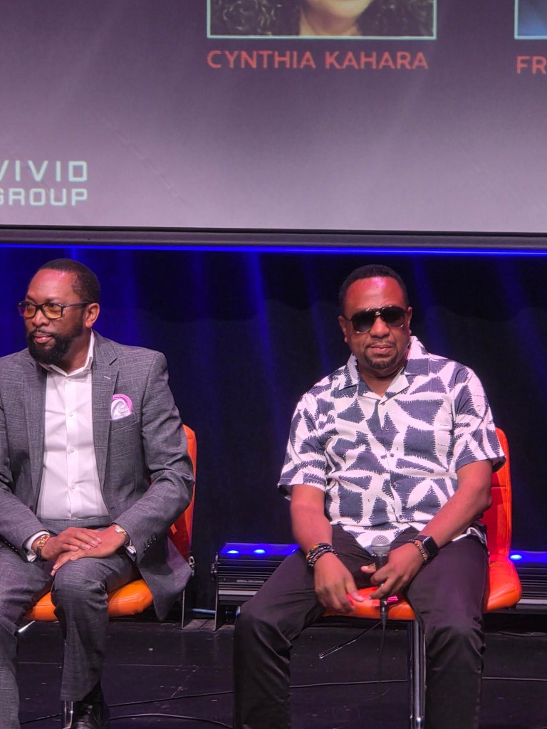 Phantoms lead singer Pierre Raymond “King Kino” Divers (left) sitting next to Alex Abellard, Zin manager, composer and keyboardist, during a ‘Konpa Se Nou’ panel on Friday, July 24, 2026. Photo by Darlie Gervais for The Haitian Times
