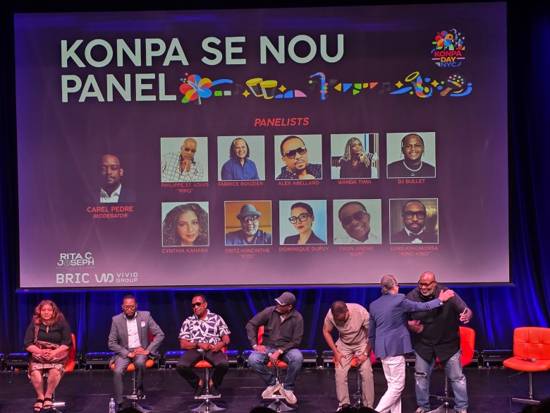 Composer Fabrice Rouzier sharing a hug with Carimi manager and Fritz ‘Fito Farinen’ Hyacinthe at ‘Konpa Se Nou’ talk celebrating Konpa 71st anniversary, at BRIC Arts | Media House in Brooklyn on Friday, July 24, 2026. Photo by Darlie Gervais for The Haitian Times 
