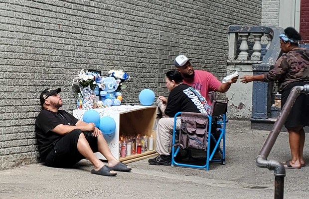 The mother of Jacob Freytes sits near a memorial for her son outside her Bronx home on Monday, July 27, 2026. (Nicholas Williams / New York Daily News)