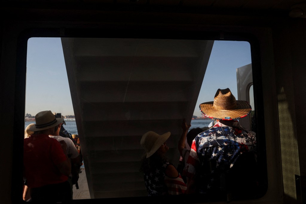 People wearing U.S.-themed outfits on a ferry, celebrating Independence Day.