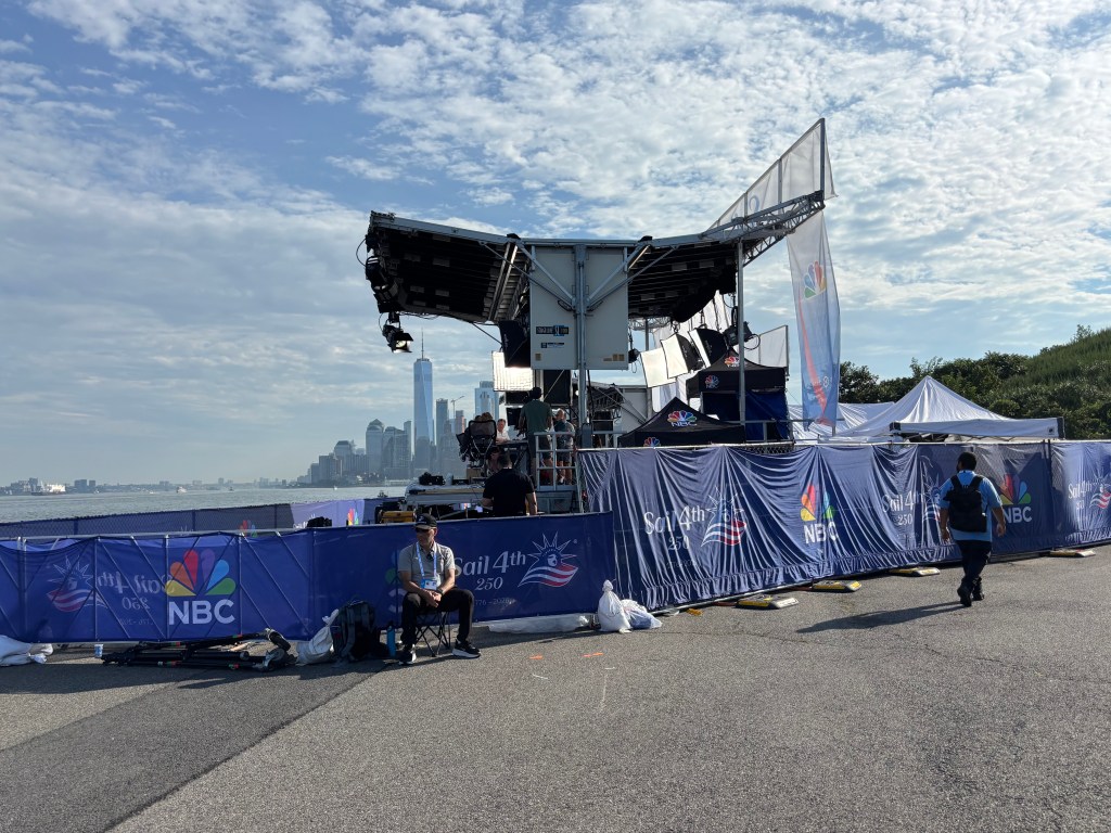 NBC broadcast booth on Governors Island for Sail 250 with New York City in the background.
