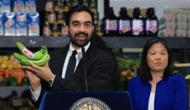 New York City Mayor Zohran Mamdani holds up bananas as he speaks at a food distribution center on July 27, 2026 in the Brooklyn borough of New York City. Mamdani announced that the five upcoming city-owned grocery stores will offer a 30 percent discount on produce, meat, bread, and milk when they begin to open next year. The discount on essential items will potentially save shoppers an estimated $90 a month, or roughly $1,000 a year, as prices for food and other items continue to rise throughout the country. The mayor has pledged one community grocery store for each borough. (Photo by Spencer Platt/Getty Images)
