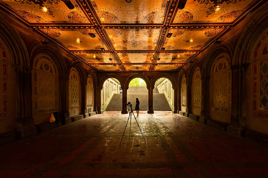 2 - Sunlight helps illuminate the intricately detailed ceilings and walls of the Bethesda Arcade, where a woman soaks in the atmosphere.