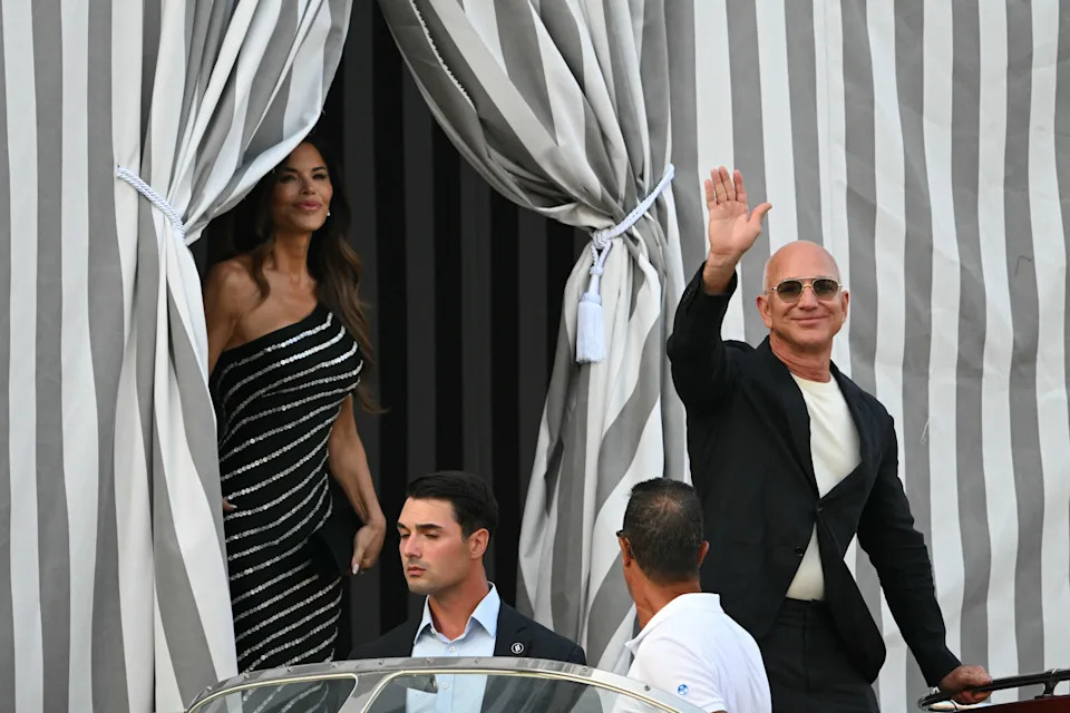 Lauren Sanchez and Jeff Bezos leave a tented area at the Aman Hotel in Venice on June 25, 2025.