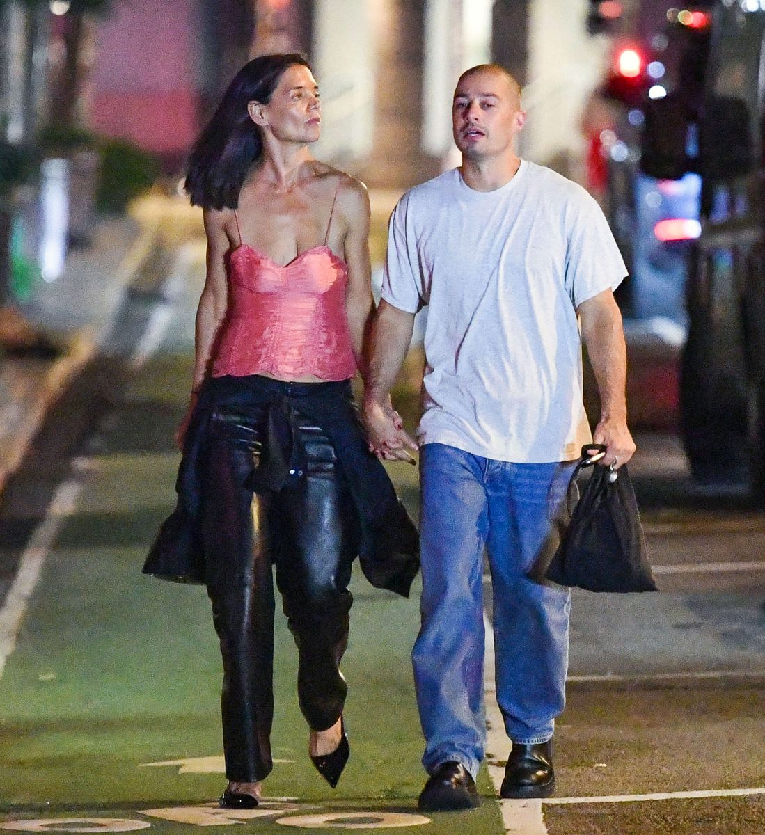 Katie Holmes and artist Jason Bard Yarmosky hold hands as they attend a SoHo Sessions event benefiting Animal League in New York City