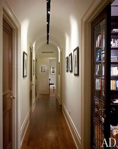 Along the barrel-vaulted hallway, which Ciccone designed and architect Stephen Wang executed, are numerous vintage prints, including Nude, 1929, by George Platt Lynes (at rear) and a series of nude distortions by André Kertész.