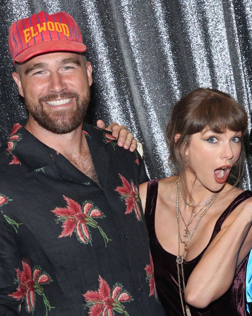 photo of travis kelce and taylor swift playfully posing