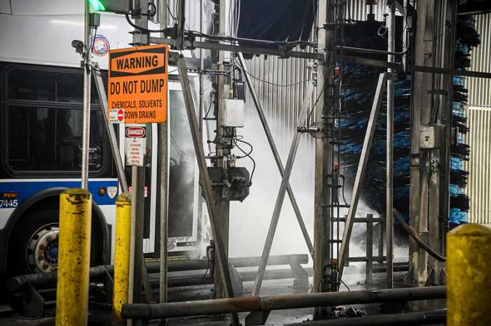 An MTA bus undergoes cleaning at the LaGuardia Bus Depot. Photo via MTA/Marc Hermann.