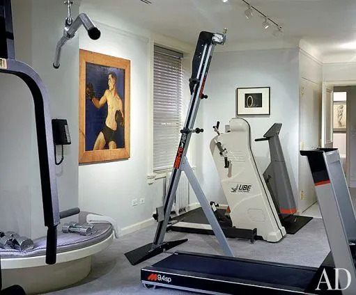 The gym is completely sound-proofed so that the stereo system (“Madonna likes to feel the music,” says her brother) can’t be heard elsewhere. At left is Portrait of a Boxer, mid-1940s, by Claggett Wilson and an untitled 1927 photograph by František Drtikol.