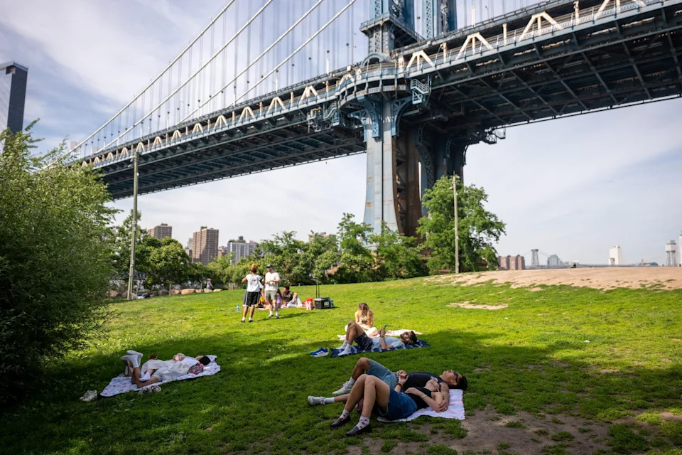 NEW YORK, NEW YORK - JUNE 04: People enjoy a warm afternoon in the Dumbo neighborhood of Brooklyn on June 04, 2026 in New York City. Temperatures are expected to reach the mid 90's in New York on Friday and Saturday as the city gears up for the summer season.