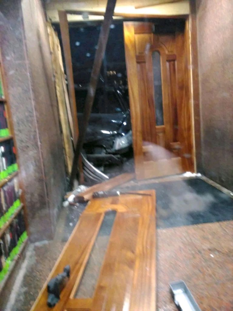 Damaged wooden doors inside a synagogue after a car crashed into it.