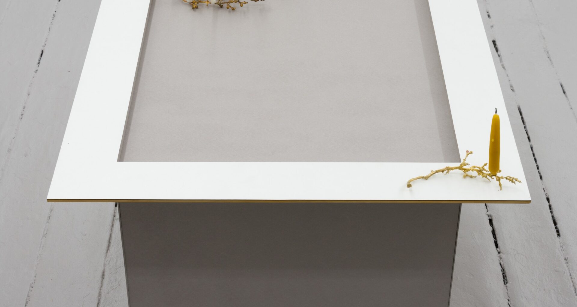 Molly Rose Lieberman, The candle is on the table, 2026. Bookboard, mdf frame, bronze, beeswax candles, 23 ½ × 27 ¼ × 23 ¼ inches. Courtesy the artist and Theta, New York.