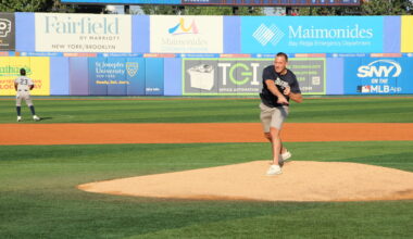 Mike Baccellieri, son of Chief Joe Baccellieri Jr., throws out one of the first pitches in honor of his father. Photo: Mario Belluomo/Brooklyn Eagle