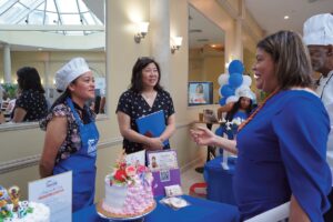 Congresswoman Grace Meng with Yoselin Genao-Estrella, Executive Director of Neighborhood Housing Services of Queen as graduates showcased beautifully decorated cakes.