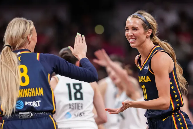 Indiana Fever guard Lexie Hull (10) high-fives Indiana Fever guard Sophie Cunningham (8) while running back to the bench during the first half of a game at Gainbridge Fieldhouse in Indianapolis on Saturday, July 18, 2026.