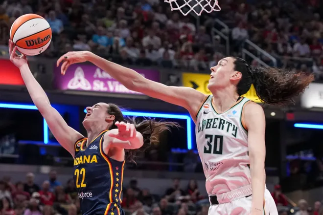 Indiana Fever guard Caitlin Clark (22) goes up for a basket against New York Liberty forward Breanna Stewart (30) during the second half of a game at Gainbridge Fieldhouse in Indianapolis on Saturday, July 18, 2026.
