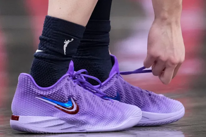 Indiana Fever guard Caitlin Clark (22) ties her Nike Signature "Caitlin 1" shoes during the first half of a game at Gainbridge Fieldhouse in Indianapolis on Saturday, July 18, 2026.