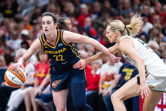 Jul 18, 2026; Indianapolis, Indiana, USA; Indiana Fever guard Caitlin Clark (22) dribbles the ball while New York Liberty guard Marine Johannes (23) defends in the first half at Gainbridge Fieldhouse. Mandatory Credit: Trevor Ruszkowski-Imagn Images
