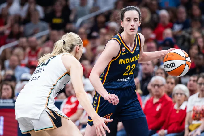 Jul 18, 2026; Indianapolis, Indiana, USA; Indiana Fever guard Caitlin Clark (22) dribbles the ball while New York Liberty guard Marine Johannes (23) defends in the first half at Gainbridge Fieldhouse. Mandatory Credit: Trevor Ruszkowski-Imagn Images