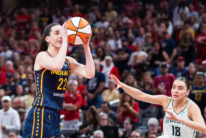Jul 18, 2026; Indianapolis, Indiana, USA; Indiana Fever guard Caitlin Clark (22) shoots the ball while New York Liberty guard Pauline Astier (18) defends in the first half at Gainbridge Fieldhouse. Mandatory Credit: Trevor Ruszkowski-Imagn Images