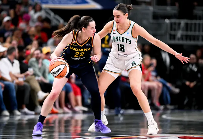 INDIANAPOLIS, INDIANA - JULY 18: Caitlin Clark #22 of the Indiana Fever dribbles against Pauline Astier #18 of the New York Liberty during the second half at Gainbridge Fieldhouse on July 18, 2026, in Indianapolis, Indiana. NOTE TO USER: User expressly acknowledges and agrees that, by downloading and or using this photograph, User is consenting to the terms and conditions of the Getty Images License Agreement. (Photo by Bobby Goddin/Getty Images)