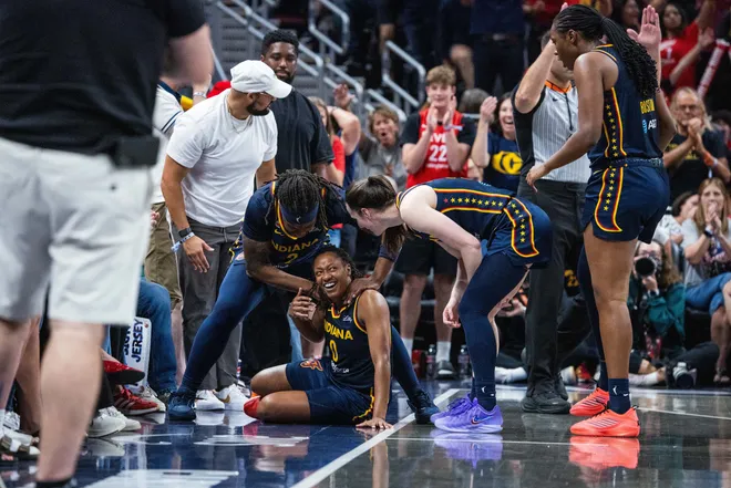 Jul 18, 2026; Indianapolis, Indiana, USA; Indiana Fever guard Kelsey Mitchell (0) celebrates a made 3-point basket and a foul with guard Caitlin Clark (22) in the second half against the New York Liberty at Gainbridge Fieldhouse. Mandatory Credit: Trevor Ruszkowski-Imagn Images