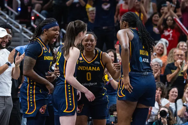 Jul 18, 2026; Indianapolis, Indiana, USA; Indiana Fever guard Kelsey Mitchell (0) celebrates a made 3-point basket and a foul with teammates in the second half against the New York Liberty at Gainbridge Fieldhouse. Mandatory Credit: Trevor Ruszkowski-Imagn Images