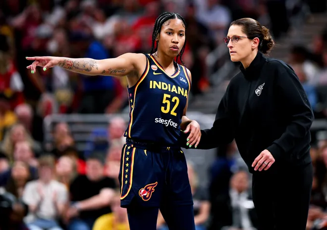INDIANAPOLIS, INDIANA - JULY 18: Tyasha Harris #52 of the Indiana Fever talks with head coach Stephanie White of the Indiana Fever against the New York Liberty during the second half at Gainbridge Fieldhouse on July 18, 2026, in Indianapolis, Indiana. NOTE TO USER: User expressly acknowledges and agrees that, by downloading and or using this photograph, User is consenting to the terms and conditions of the Getty Images License Agreement. (Photo by Bobby Goddin/Getty Images)