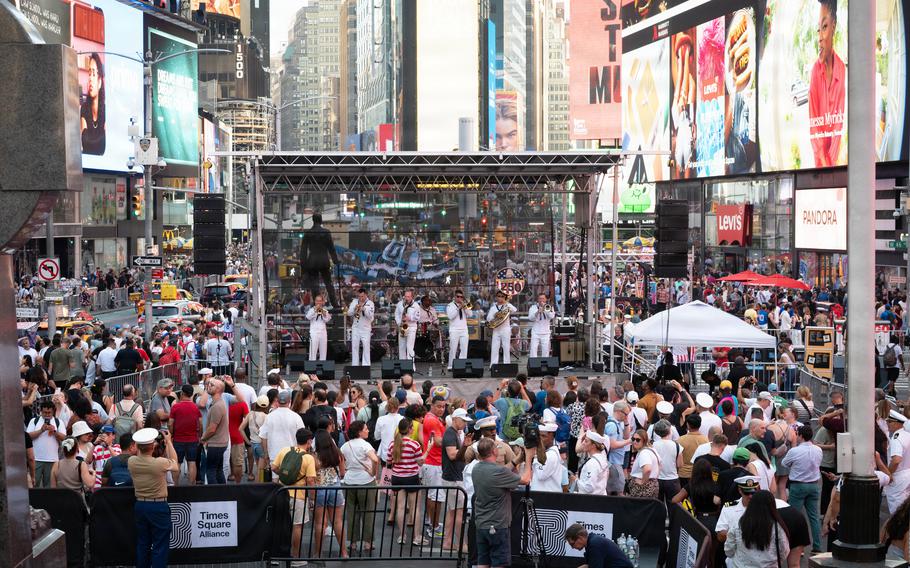 A crowd gathers around as the band plays.