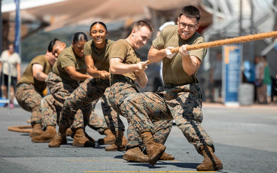 Six Marines tug on the rope.