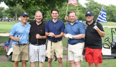 Two flags, one spirit — Ahepan brothers raise the American and Greek colors at Dyker Beach. Photo: Courtesy of AHEPA