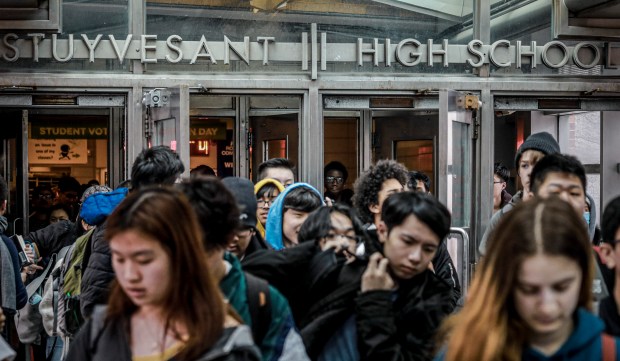 In this March 13, 2020, file photo, students exit Stuyvesant High School in Manhattan. (AP Photo/Bebeto Matthews, File)