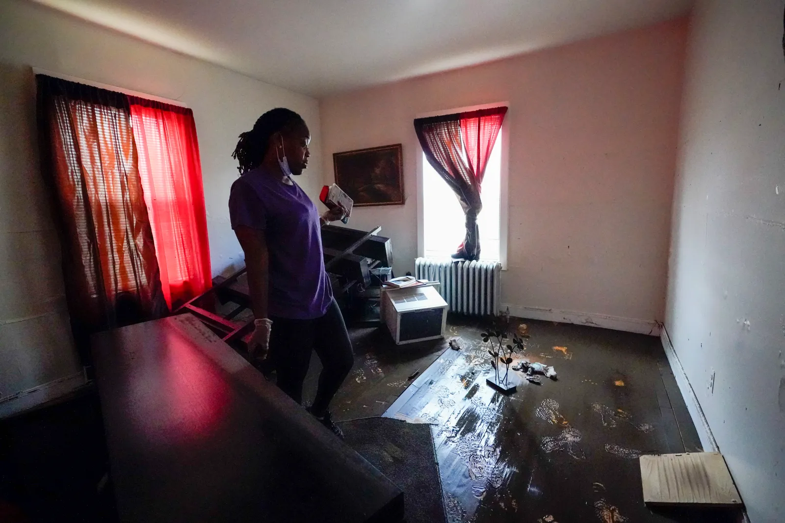 Melissa Weekes searches her flooded apartment for salvageable items on September 3, 2021, in Mamaroneck, New York.