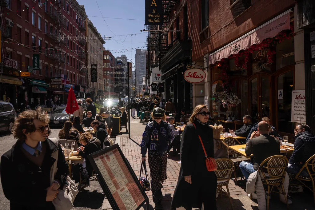 People dine at an Italian restaurant in New York's Little Italy neighborhood.