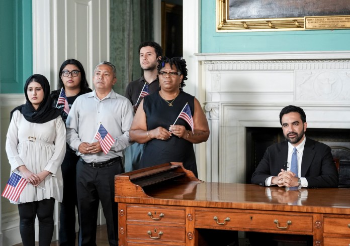 Mayor Zohran Mamdani delivers an address from George Washington's desk, surrounded by recently naturalized citizens, to commemorate America's 250th anniversary on Friday, July 3, 2026, in New York.