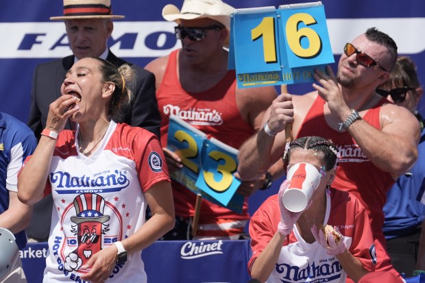 Miki Sudo and other competitive eaters consume hot dogs during the 2026 Nathan's Famous Fourth of July hot dog eating contest at Coney Island in Brooklyn on Saturday, July 4, 2026. (AP Photo/Anna Connors)