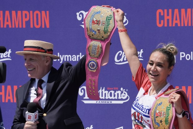 MC George Shea presents competitive eater Miki Sudo with the champion belt after winning the women's 2026 Nathan's Famous Fourth of July hot dog eating contest at Coney Island in Brooklyn, New York, Saturday, July 4, 2026. (AP Photo/Anna Connors)