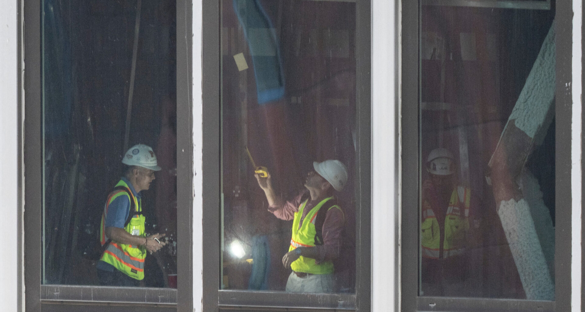 People inspect a buckled support beam inside 235 East 42nd Street, Wednesday, July 8, 2026, in New York. (AP Photo/Yuki Iwamura)