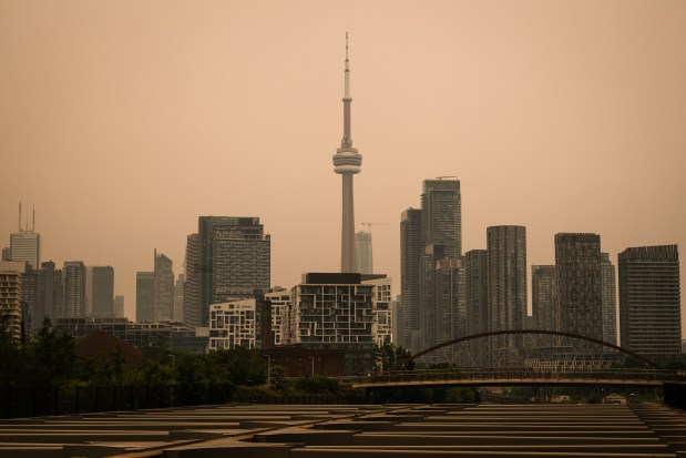 The CN Tower is pictured in Toronto as wildfire smoke fills the city, on Wednesday, July 15, 2026. (Laura Proctor/The Canadian Press via AP)