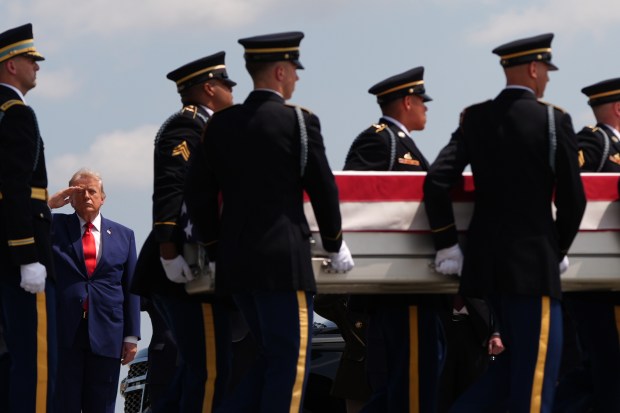 President Donald Trump salutes as a U.S. Army carry team moves a transfer case containing the remains of Sgt. Angel S. Rampersad, of Ozone Park, N.Y. Wednesday, July 22, 2026, at Dover Air Force Base, Del. (AP Photo/Julia Demaree Nikhinson)