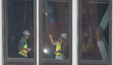 People inspect a buckled support beam inside 235 East 42nd Street, Wednesday, July 8, 2026, in New York.
