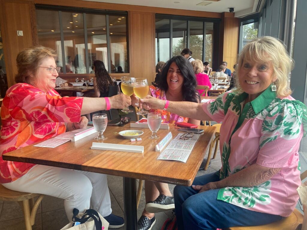 Three women at a mah jongg table