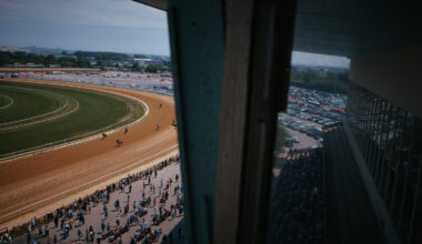 Jockeys ride their horses after a race at Aqueduct Racetrack on closing day in the Queens borough o...