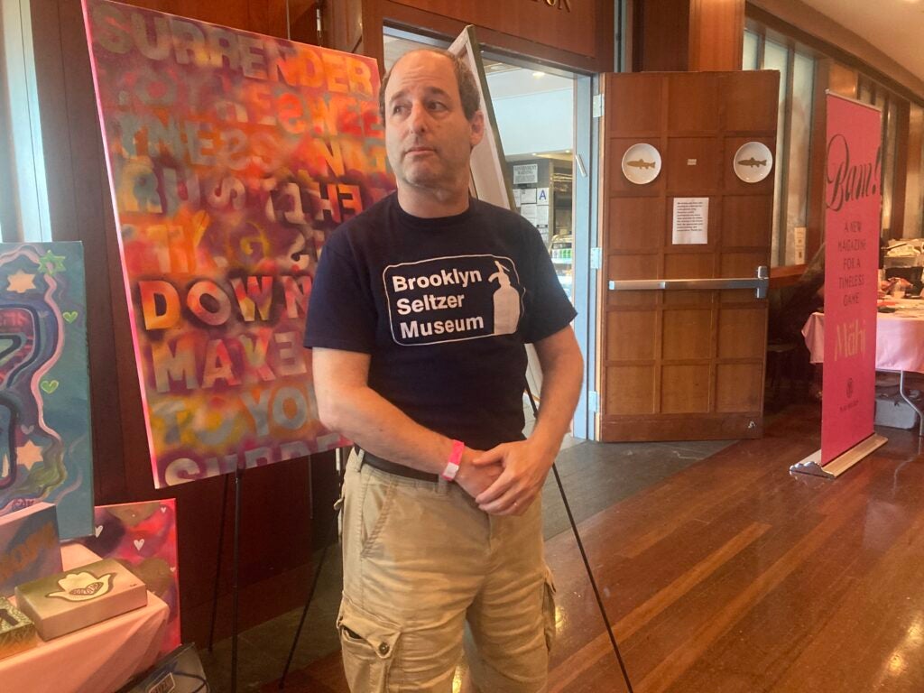 A man standing in front of a sign