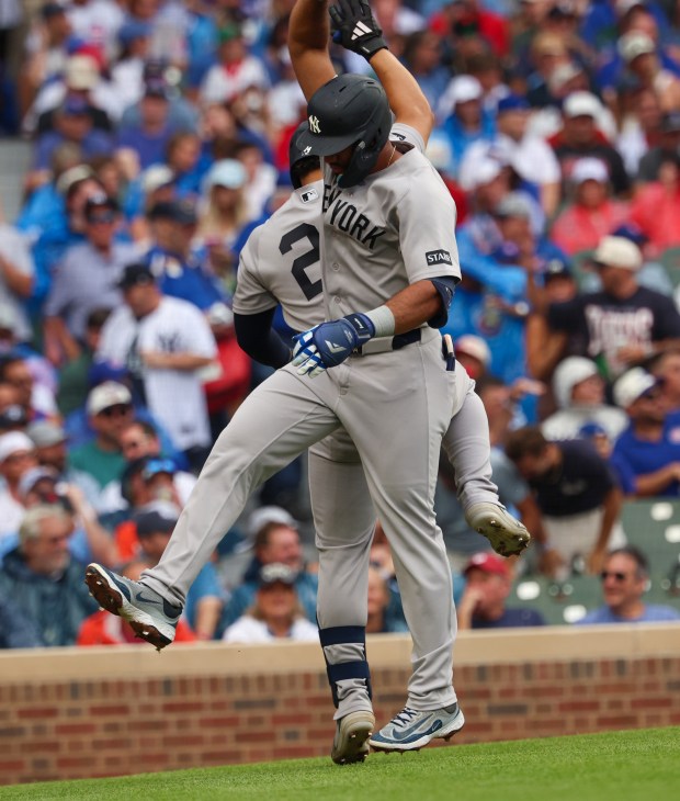 Yankees third baseman Amed Rosario, front, high-fives Jasson Domínguez after hitting a solo home run in the top of the fourth inning against the Cubs on Friday, July 31, 2026, at Wrigley Field. (Stacey Wescott/Chicago Tribune)