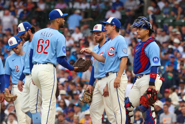 Cubs manager Craig Counsell hands the ball to reliever Antoine Kelly in the top of the eighth inning against the Yankees on Friday, July 31, 2026, at Wrigley Field. Kelly made his major-league debut in the Cubs' 2-0 loss. (Stacey Wescott/Chicago Tribune)
