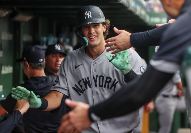 Yankees left fielder Spencer Jones (78) high-fives teammates in the dugout after hitting a solo home run against Cubs on Friday, July 31, 2026, at Wrigley Field. (Stacey Wescott/Chicago Tribune)