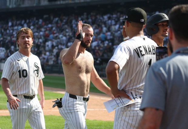 Chicago White Sox center fielder Tristan Peters high-fives manager Will Venable after losing his shirt in the celebration of his walk-off walk to defeat the New York Yankees 2-1 on Thursday, July 30, 2026, at Rate Field. (Brian Cassella/Chicago Tribune)