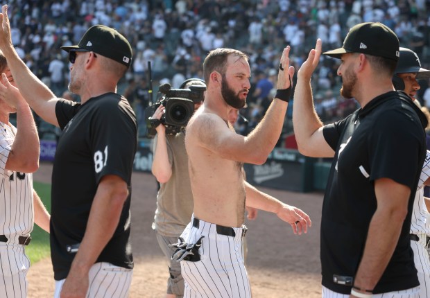 Chicago White Sox center fielder Tristan Peters high-fives teammates after losing his shirt in the celebration of his walk-off walk to defeat the New York Yankees 2-1 in 11 innings Thursday, July 30, 2026, at Rate Field. (Brian Cassella/Chicago Tribune)
